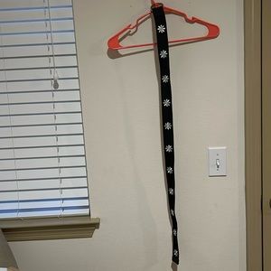 Black belt with white flowers on it. Belt in about 36 inches long or 89cm long.